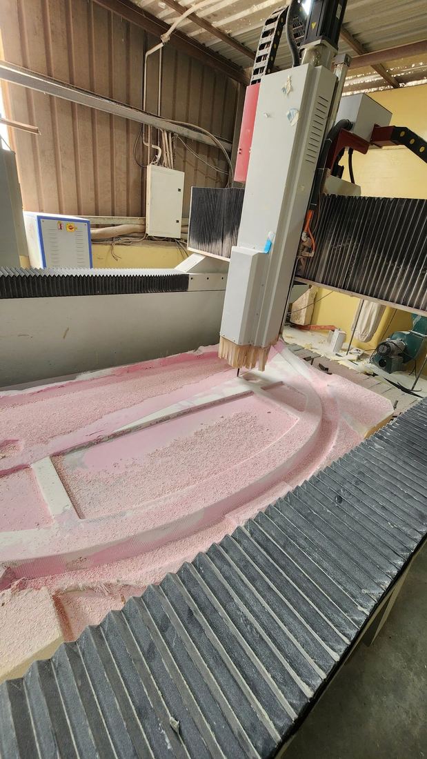 5-axis CNC machining of the cockpit fairing mould, cut from high-density foam ahead of composite lay-up.